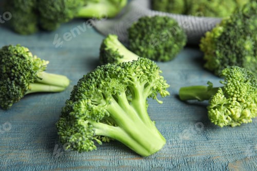 Preview: Fresh green broccoli on blue wooden table, closeup