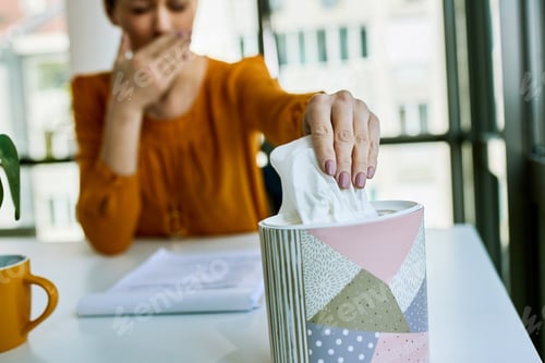 Preview: Close-up of businesswoman taking tissue from a box.