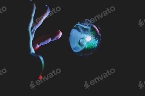 Preview: Hand trying to touch a magic colorful ball