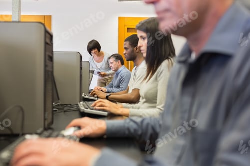 Preview: Teacher Helping Her Students In Computer Class In College