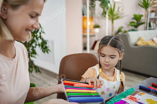 Preview: Mother and daughter engage in creative painting at home on a sun