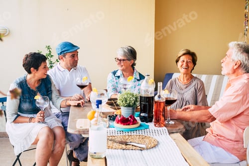Preview: Group of friends mixed ages adult and senior have fun together enjoying food and drinks