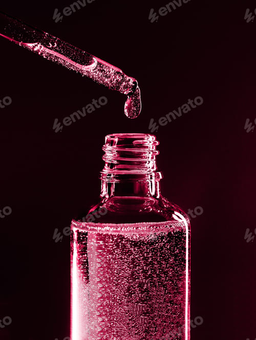 Preview: serum pipette with a falling drop on a dark background
