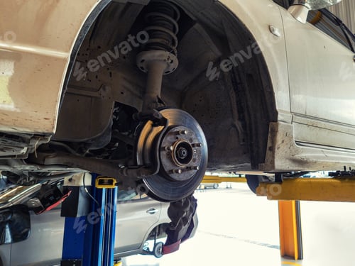 Preview: Damaged car and dirty disc brake lifting for maintenance in workshop