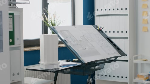 Preview: Close up of blueprints plan and building model on table in empty space used for construction