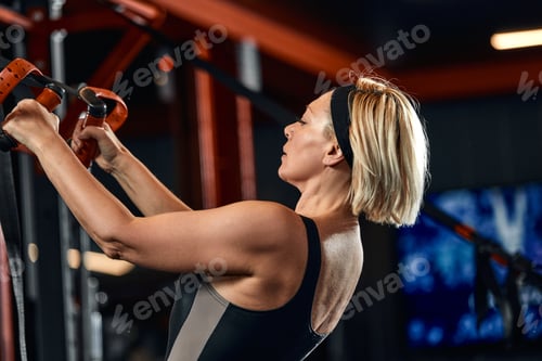 Preview: Women doing push ups training arms with trx fitness straps in the gym Concept workout healthy