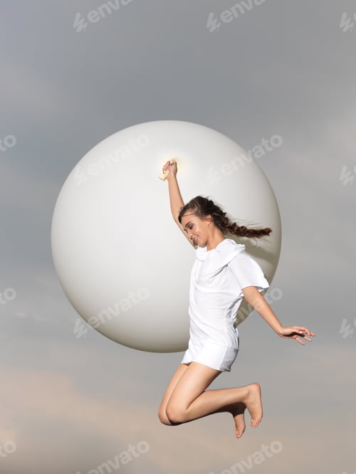 Preview: happy woman jumping with big, white balloon