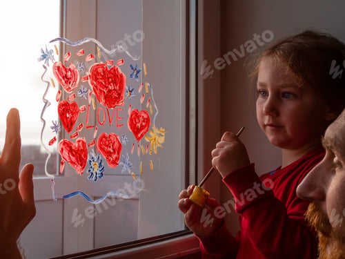 Preview: Child with father painting Love sign, playing indoors quarantine family leisure. Little girl smiles