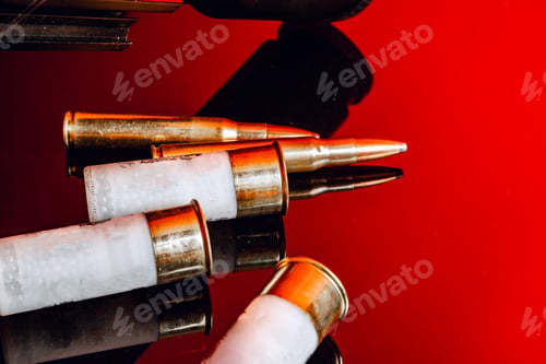 Preview: Rifle bullets or cartridges on black shiny background