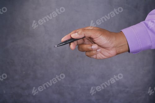 Preview: side view of holding a pen pointing something against black background