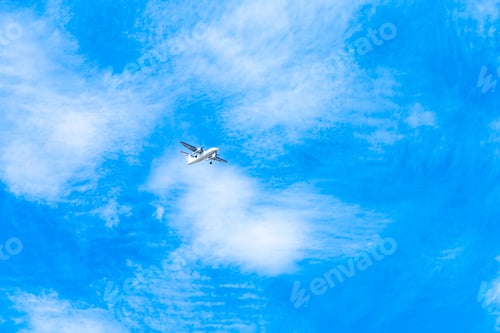 Preview: landing plane on blue sky with clouds