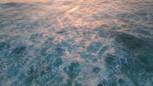 Preview: Foamy sea water splashing seashore stones. Aerial stormy blue waves rolling rock