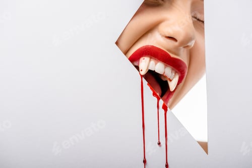 Preview: cropped shot of girl with vampire teeth and blood biting through hole on white