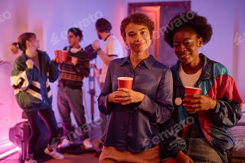 Preview: Two girls at retro house party holding red cups and