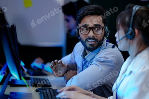 Preview: A diverse team of professionals works at a customer support call center.