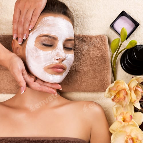 Preview: Woman with mask on her face having head massage.