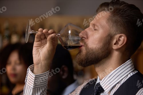 Preview: Sommelier Taking Sip of Wine with Great Pleasure