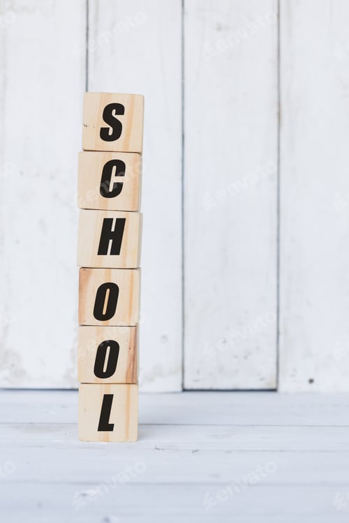 Preview: wooden cube, with the word school, with white wooden background