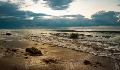 Preview: Sandy beach with stones in the early morning