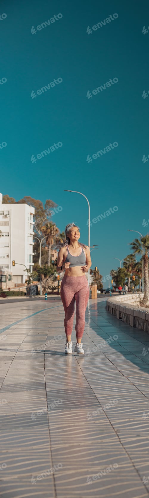 Preview: Slender athletic lady training by the waterfront
