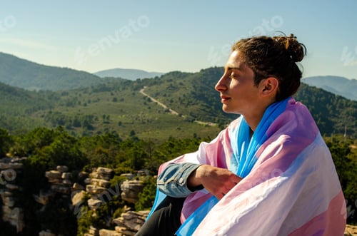 Preview: Shaved Long Hair Young Man Sitting at Nature Breathing Deep with Closed Eyes Wrapped with Transgend