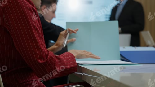 Preview: Business team meeting together talking and planing project paperwork