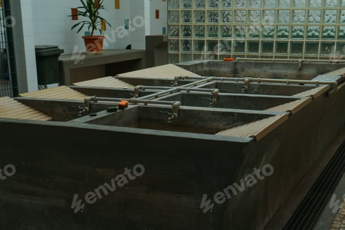 Preview: Old but functioning public laundry of an obsolete type in Lisbon. Dark gray sinks with washboards