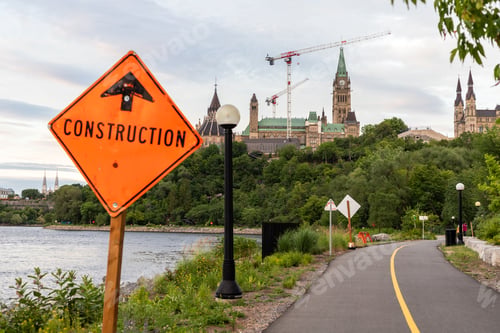 Preview: Construction sign on road and panoramic view of Ottawa River and Parliament under renovation