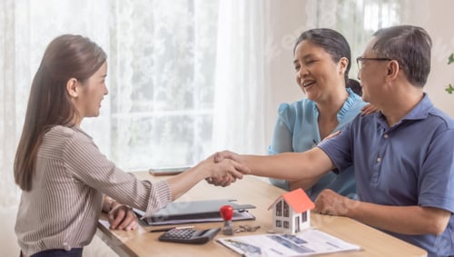 Preview: Elderly couples satisfying retirement home purchase with contract and key handover from a saleswoman