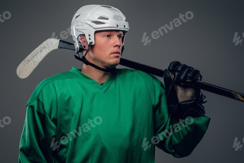 Preview: Portrait of hockey player isolated on grey background.