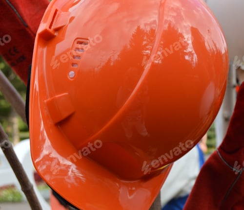 Preview: Closeup of a red protective helmet, outdoor