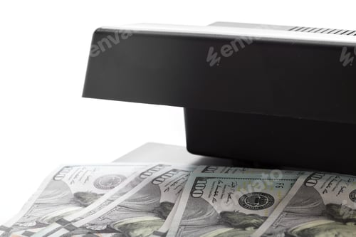 Preview: Money being processed by a scanner in a light background setting