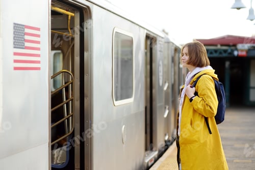 Preview: Beautiful young woman is waiting for a train on a platform in the New York subway. Transport of NYC