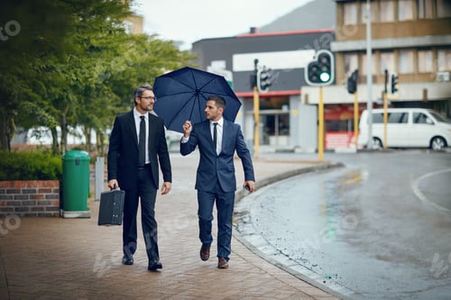 Preview: Shot of two corporate businessmen travelling through the city on a rainy day