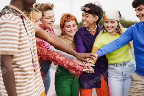 Preview: Multiethnic friends stacking hands outdoor