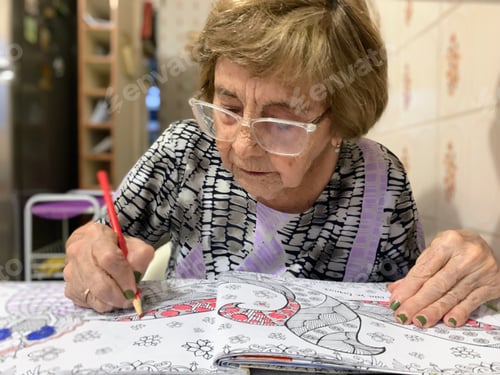 Preview: Elderly woman painting in her sketchbook