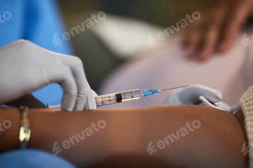 Preview: Caucasian Woman Receiving Injection from Medical Professional in Home Setting