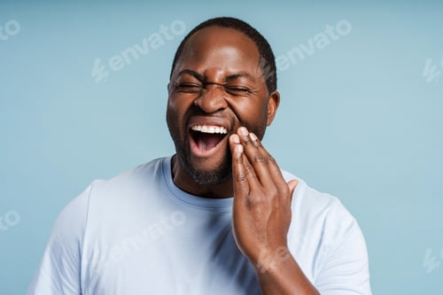 Preview: African American man feeling strong toothache posing in studio