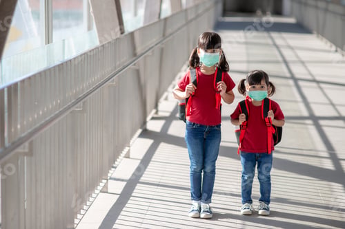 Preview: Portrait image of little cute Asian children siblings wearing a face mask and take a school bag.