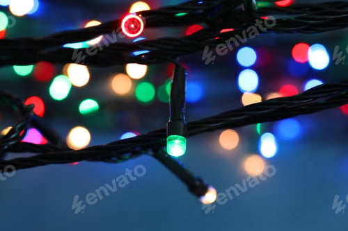 Preview: Beautiful Christmas lights on color background, closeup