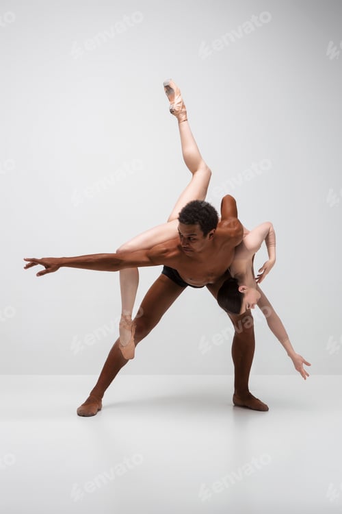 Preview: Couple of ballet dancers posing over gray background