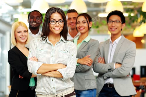 Preview: Smiling Group Of Co-Workers Standing In Office