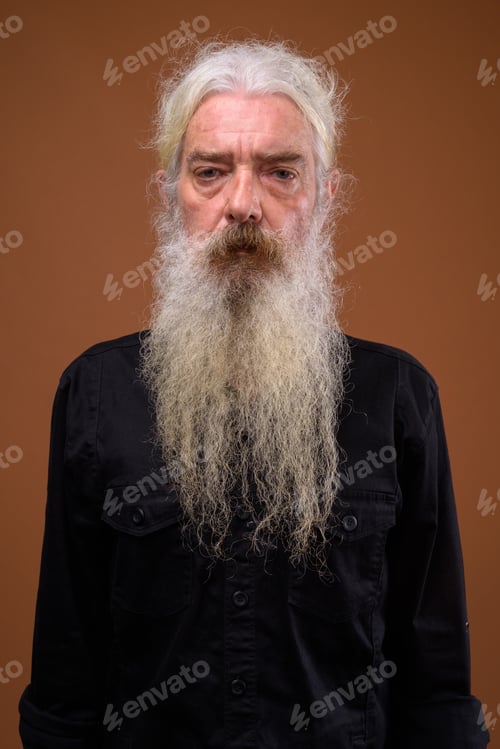Preview: Portrait of senior bearded man against brown background