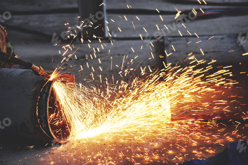 Preview: worker in factory cutting steel pipe using metal torch