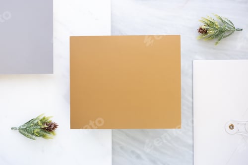 Preview: Top view of blank gold card overlap on white envelop on two layer step of marble table