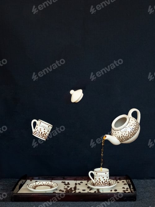 Preview: Vertical shot of coffee being magically poured into a cup with another cup floating around