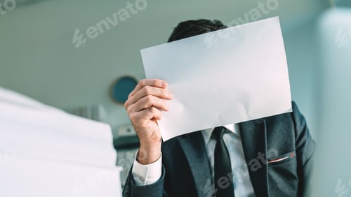 Preview: Unrecognizable business person holding blank white mockup paper in front of his face