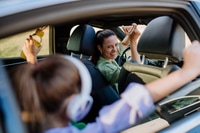 Preview: Young mother and her daughter having fun in their electric car.