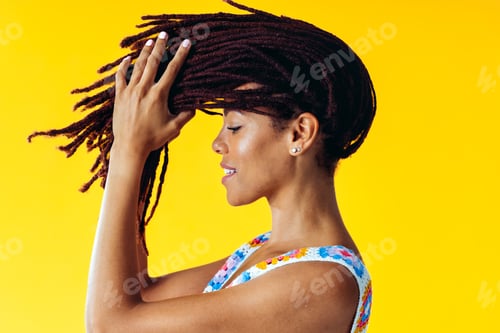 Preview: Woman posing on colored backgrounds in studio wearing trendy clothes