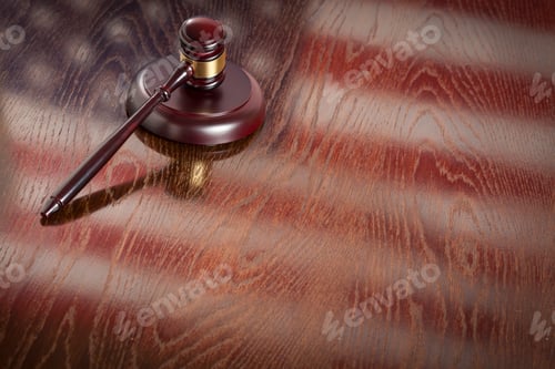 Preview: Wooden Gavel Resting on American Flag Reflecting Table.